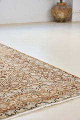 Dusty is an antique Mahal carpet featuring a beautiful intricate floral motif in pinks, beige and dark brown