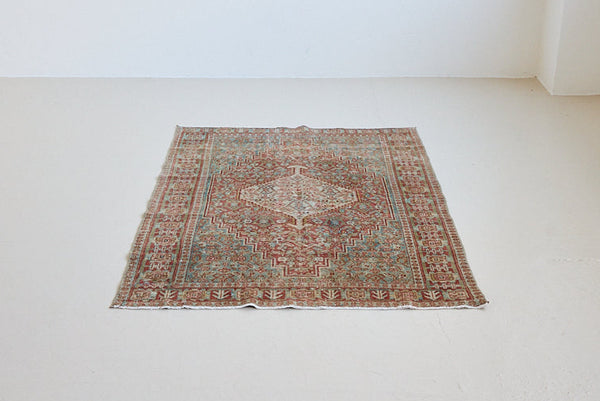 Tallulah is an antique Mahal rug. This carpet features an incredible palette of soft terracotta, blues and greens and a stunning intricate design.