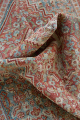 Tallulah is an antique Mahal rug. This carpet features an incredible palette of soft terracotta, blues and greens and a stunning intricate design.