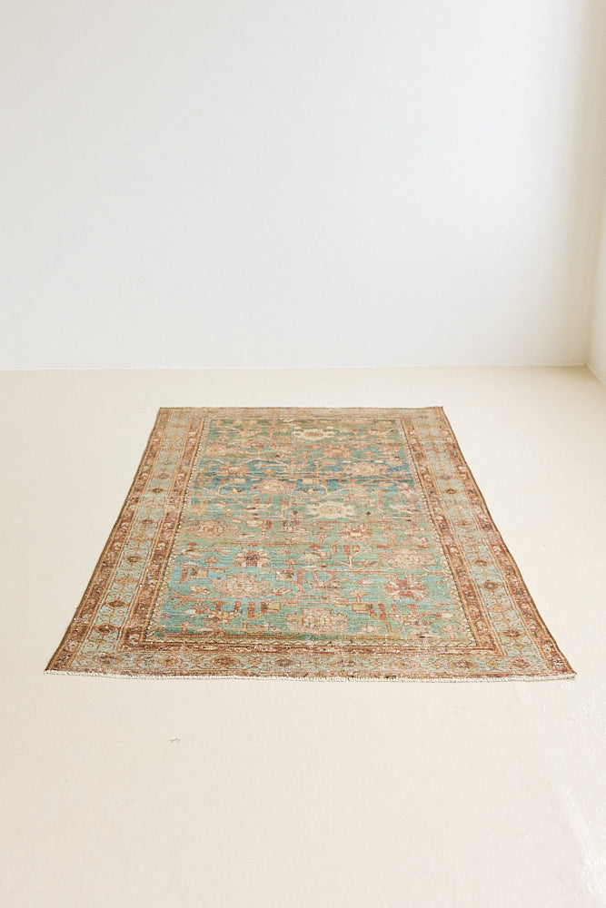 Alina an antique Persian Malayer rug with a blue field and an earthy pink intricate all over floral design