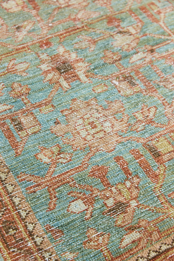Alina an antique Persian Malayer rug with a blue field and an earthy pink intricate all over floral design