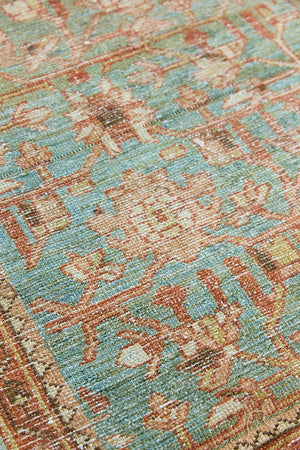Alina an antique Persian Malayer rug with a blue field and an earthy pink intricate all over floral design