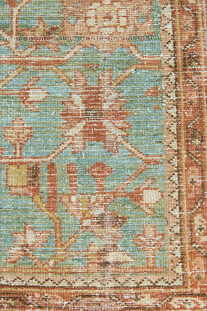 Alina an antique Persian Malayer rug with a blue field and an earthy pink intricate all over floral design