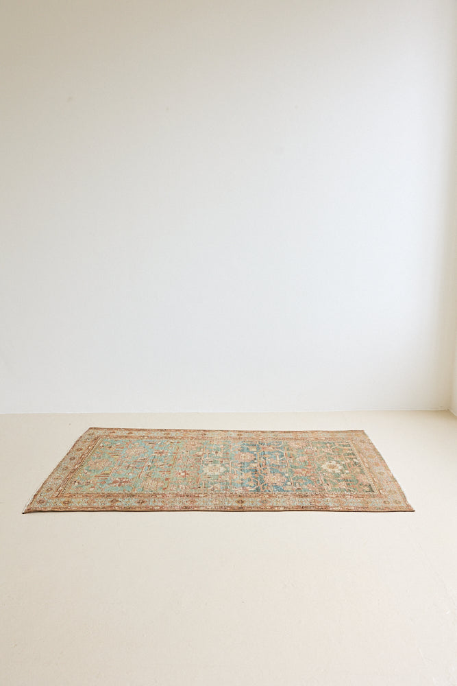 Alina an antique Persian Malayer rug with a blue field and an earthy pink intricate all over floral design