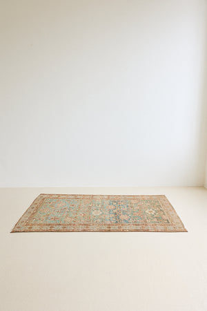 Alina an antique Persian Malayer rug with a blue field and an earthy pink intricate all over floral design