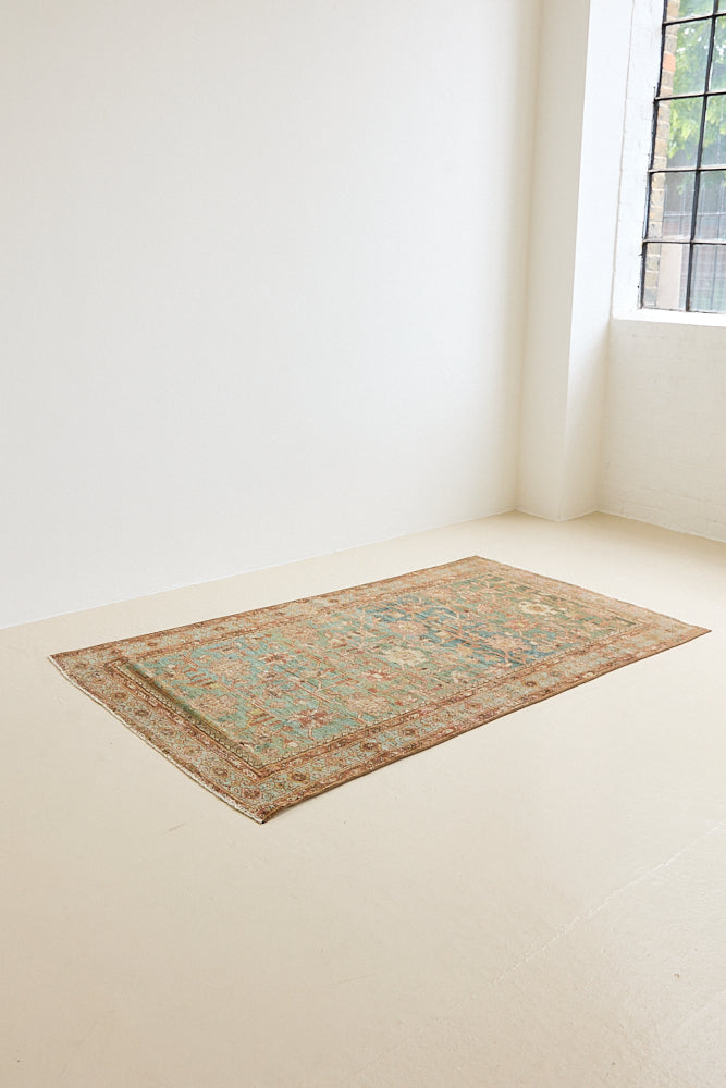 Alina an antique Persian Malayer rug with a blue field and an earthy pink intricate all over floral design
