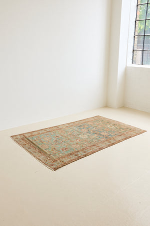 Alina an antique Persian Malayer rug with a blue field and an earthy pink intricate all over floral design