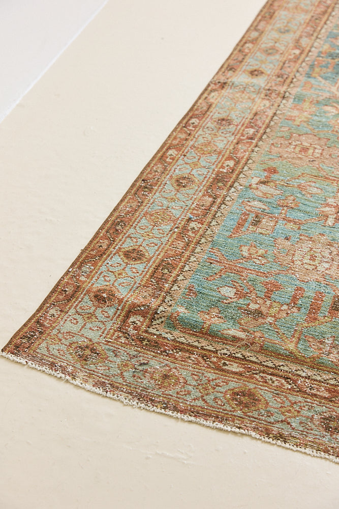 Alina an antique Persian Malayer rug with a blue field and an earthy pink intricate all over floral design