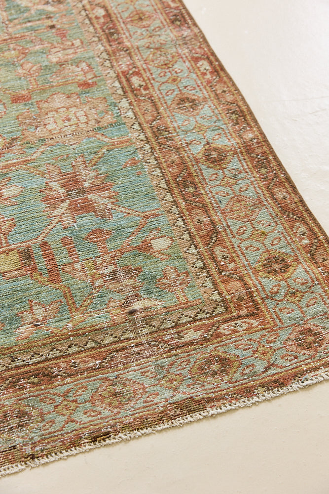 Alina an antique Persian Malayer rug with a blue field and an earthy pink intricate all over floral design