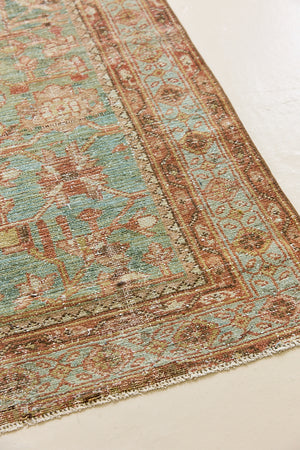 Alina an antique Persian Malayer rug with a blue field and an earthy pink intricate all over floral design