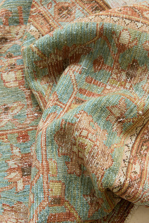 Alina an antique Persian Malayer rug with a blue field and an earthy pink intricate all over floral design
