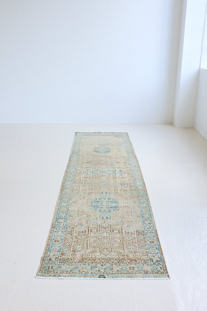 The Heriz is one of the most sought after and recognisable Persian designs, known for vibrant colours and bold geometric patterns. This runner features a beautiful colour palette of taupe, blue and muted brown.
