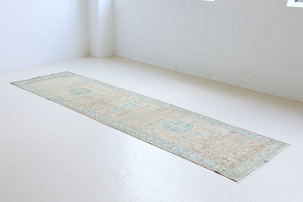 The Heriz is one of the most sought after and recognisable Persian designs, known for vibrant colours and bold geometric patterns. This runner features a beautiful colour palette of taupe, blue and muted brown.