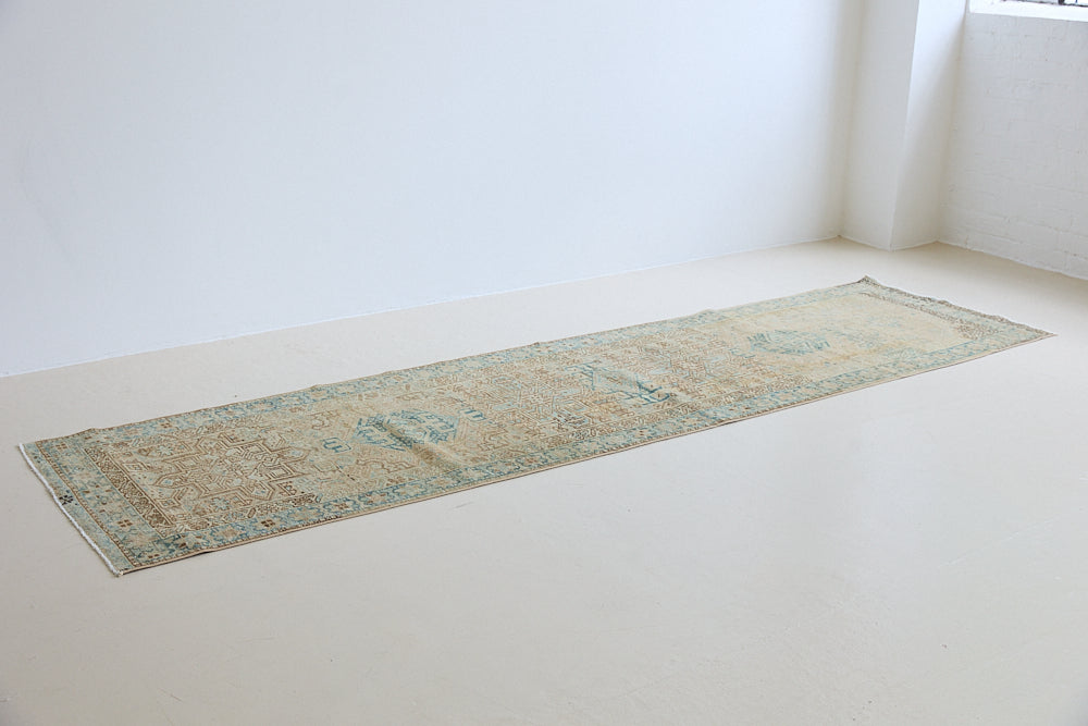 The Heriz is one of the most sought after and recognisable Persian designs, known for vibrant colours and bold geometric patterns. This runner features a beautiful colour palette of taupe, blue and muted brown.