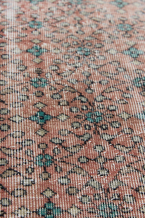 Dot is a vintage Turkish wool rug handwoven in Turkey approximately 80 years ago. The warm terracotta field and is decorated with an all floral scrolls pattern framed by a contrasting taupe boarder. 