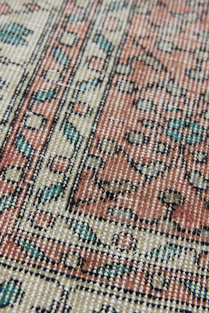 Dot is a vintage Turkish wool rug handwoven in Turkey approximately 80 years ago. The warm terracotta field and is decorated with an all floral scrolls pattern framed by a contrasting taupe boarder. 