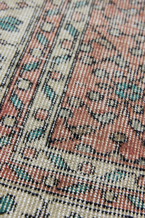 Dot is a vintage Turkish wool rug handwoven in Turkey approximately 80 years ago. The warm terracotta field and is decorated with an all floral scrolls pattern framed by a contrasting taupe boarder. 
