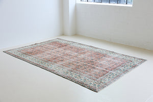 Dot is a vintage Turkish wool rug handwoven in Turkey approximately 80 years ago. The warm terracotta field and is decorated with an all floral scrolls pattern framed by a contrasting taupe boarder. 