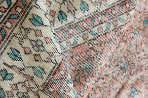 Dot is a vintage Turkish wool rug handwoven in Turkey approximately 80 years ago. The warm terracotta field and is decorated with an all floral scrolls pattern framed by a contrasting taupe boarder. 