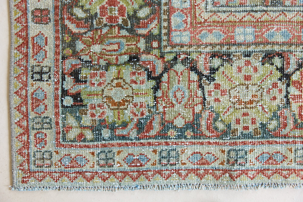 Mahals are known for decorative designs and repeating floral patterns. This antique rug features a beautiful earthy red ground complimented by a dark blue border.