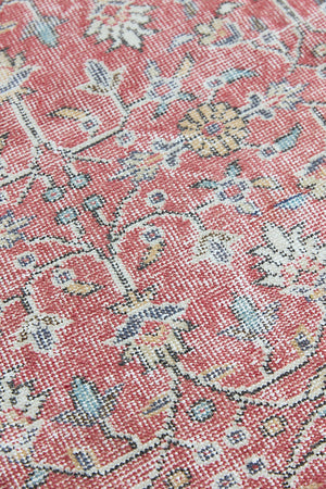Ivy is a vintage rug handwoven in Turkey approximately 80 years ago. The warm red field and soft beige border are intertwined with an all over flowering vine pattern.