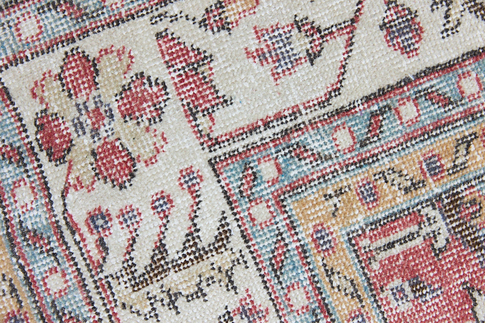 Ivy is a vintage rug handwoven in Turkey approximately 80 years ago. The warm red field and soft beige border are intertwined with an all over flowering vine pattern.