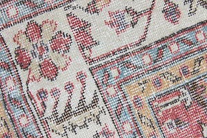 Ivy is a vintage rug handwoven in Turkey approximately 80 years ago. The warm red field and soft beige border are intertwined with an all over flowering vine pattern.