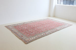 Ivy is a vintage rug handwoven in Turkey approximately 80 years ago. The warm red field and soft beige border are intertwined with an all over flowering vine pattern.