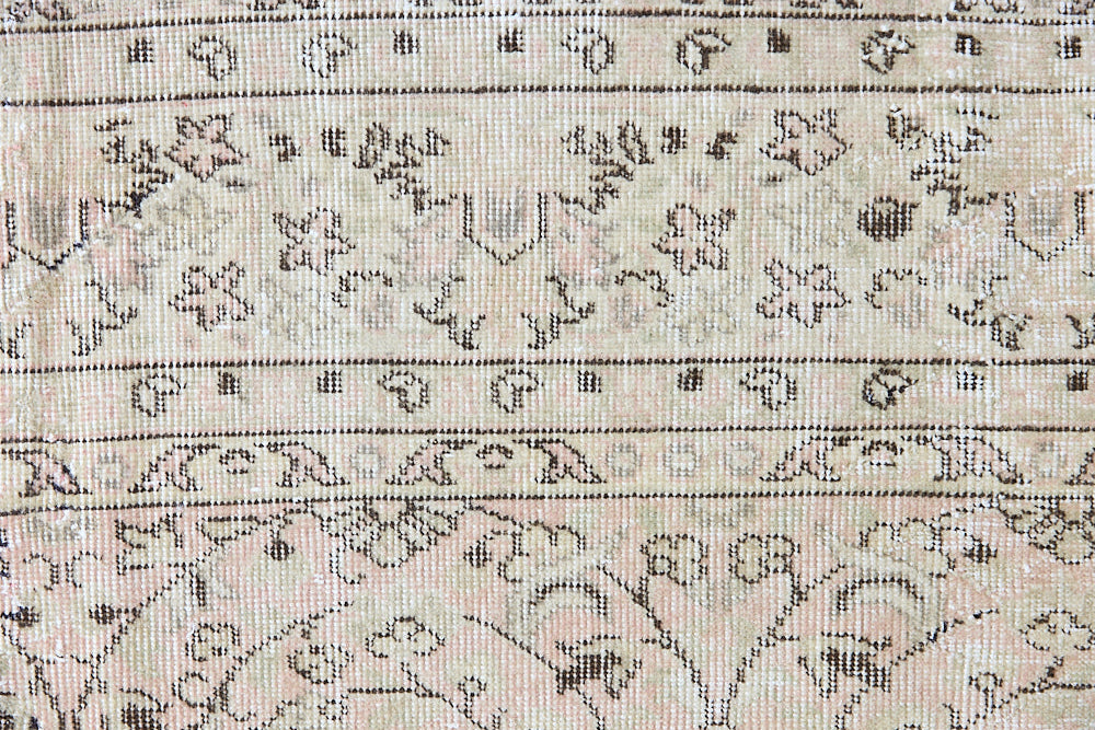 Josie is a vintage wool rug handwoven in Turkey approximately 80 years ago. The soft pink field and is decorated with an all floral scrolls pattern framed by a subtle contrasting taupe boarder.