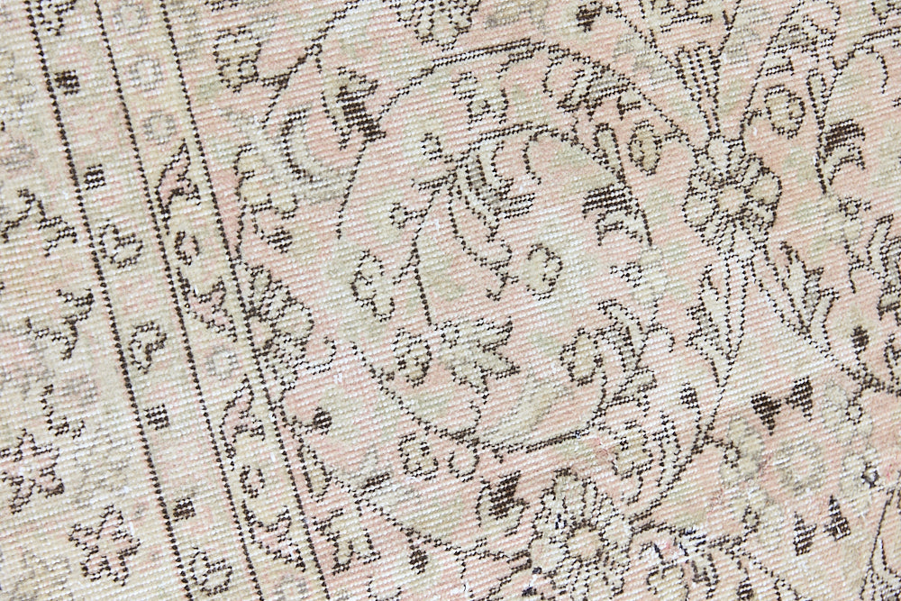 Josie is a vintage wool rug handwoven in Turkey approximately 80 years ago. The soft pink field and is decorated with an all floral scrolls pattern framed by a subtle contrasting taupe boarder.