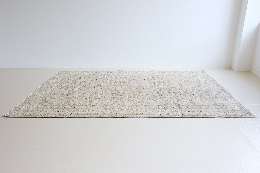 Josie is a vintage wool rug handwoven in Turkey approximately 80 years ago. The soft pink field and is decorated with an all floral scrolls pattern framed by a subtle contrasting taupe boarder.