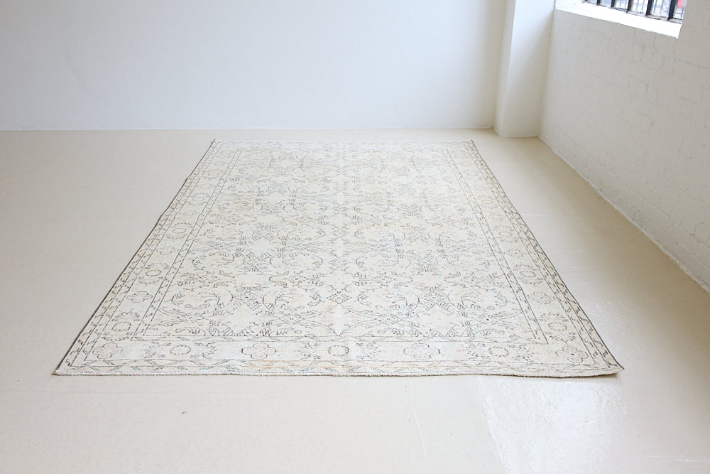 Lily is a vintage wool rug handwoven in Turkey approximately 80 years ago. The soft taupe field and is decorated with an all floral scrolls pattern framed by a subtle boarder.