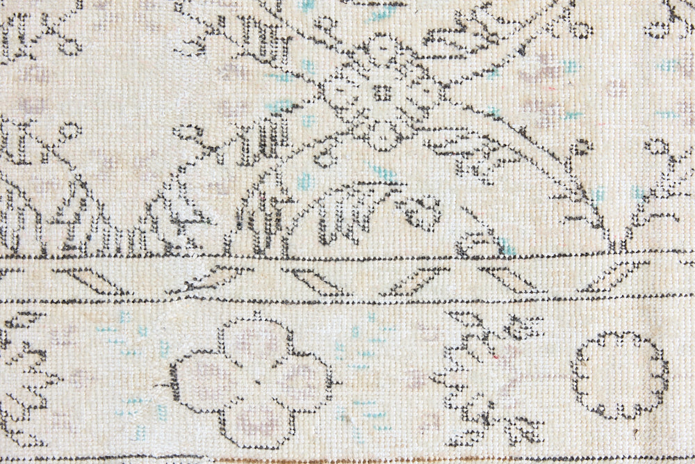 Lily is a vintage wool rug handwoven in Turkey approximately 80 years ago. The soft taupe field and is decorated with an all floral scrolls pattern framed by a subtle boarder.