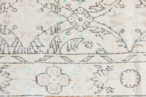 Lily is a vintage wool rug handwoven in Turkey approximately 80 years ago. The soft taupe field and is decorated with an all floral scrolls pattern framed by a subtle boarder.