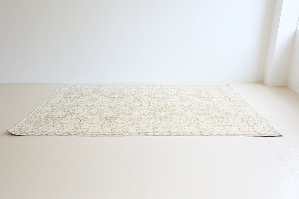 Lily is a vintage wool rug handwoven in Turkey approximately 80 years ago. The soft taupe field and is decorated with an all floral scrolls pattern framed by a subtle boarder.