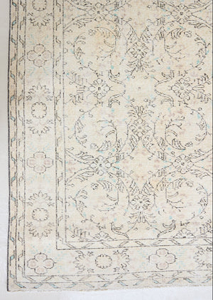 Lily is a vintage wool rug handwoven in Turkey approximately 80 years ago. The soft taupe field of this Turkish carpet is decorated with an all floral scrolls pattern framed by a subtle border.
