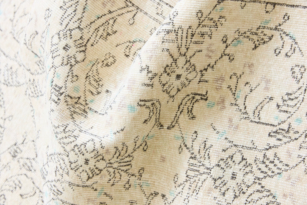 Lily is a vintage wool rug handwoven in Turkey approximately 80 years ago. The soft taupe field and is decorated with an all floral scrolls pattern framed by a subtle boarder.