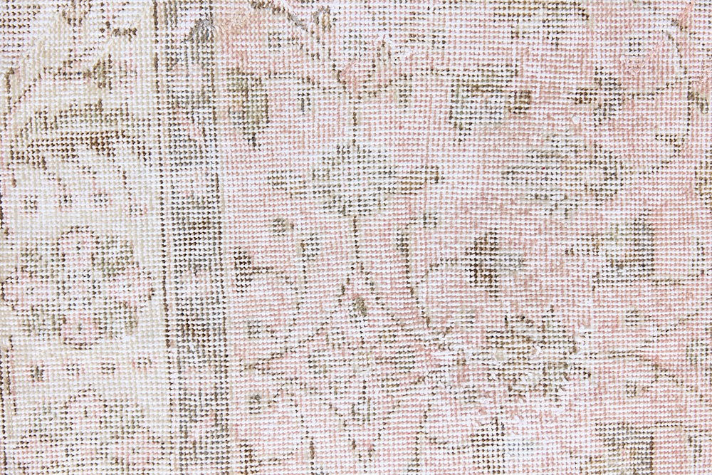 Lizzie is a vintage wool rug handwoven in Turkey approximately 70 years ago. The soft pink field and is decorated with an all floral scrolls pattern framed by a subtle contrasting taupe boarder.