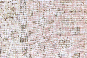 Lizzie is a vintage wool rug handwoven in Turkey approximately 70 years ago. The soft pink field and is decorated with an all floral scrolls pattern framed by a subtle contrasting taupe boarder.