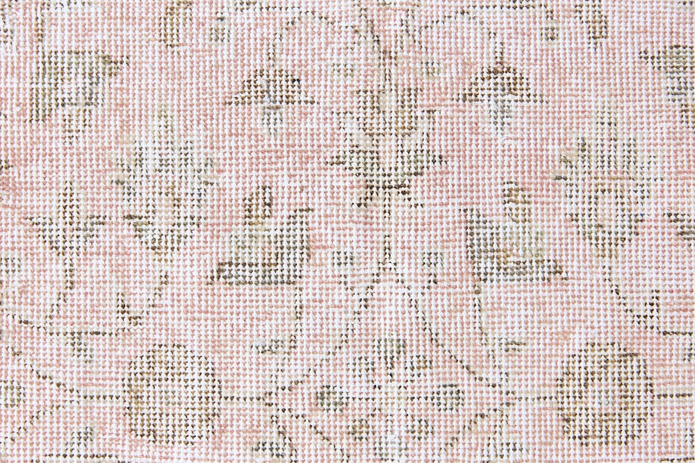 Lizzie is a vintage wool rug handwoven in Turkey approximately 70 years ago. The soft pink field and is decorated with an all floral scrolls pattern framed by a subtle contrasting taupe boarder.