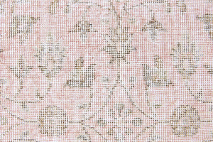 Lizzie is a vintage wool rug handwoven in Turkey approximately 70 years ago. The soft pink field and is decorated with an all floral scrolls pattern framed by a subtle contrasting taupe boarder.