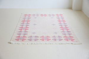 Ola is an original 1960s röllakan flatweave rug, featuring a pretty geometric floral pattern. The rug is signed ILS.