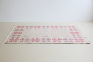 Ola is an original 1960s röllakan flatweave rug, featuring a pretty geometric floral pattern. The rug is signed ILS.
