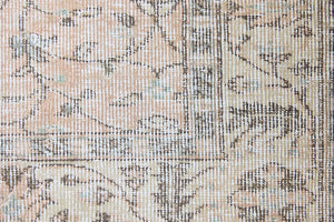 Rosh is a vintage wool rug handwoven in Turkey approximately 80 years ago. The soft terracotta field is decorated with an all floral scrolls pattern framed by a subtle contrasting taupe boarder.