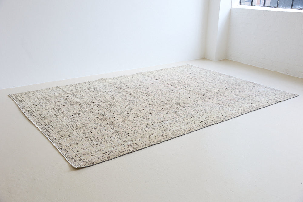 Josie is a vintage wool rug handwoven in Turkey approximately 80 years ago. The soft pink field and is decorated with an all floral scrolls pattern framed by a subtle contrasting taupe boarder.