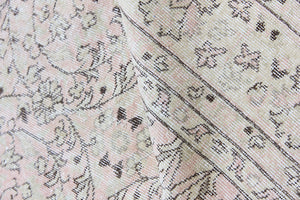 Josie is a vintage wool rug handwoven in Turkey approximately 80 years ago. The soft pink field and is decorated with an all floral scrolls pattern framed by a subtle contrasting taupe boarder.