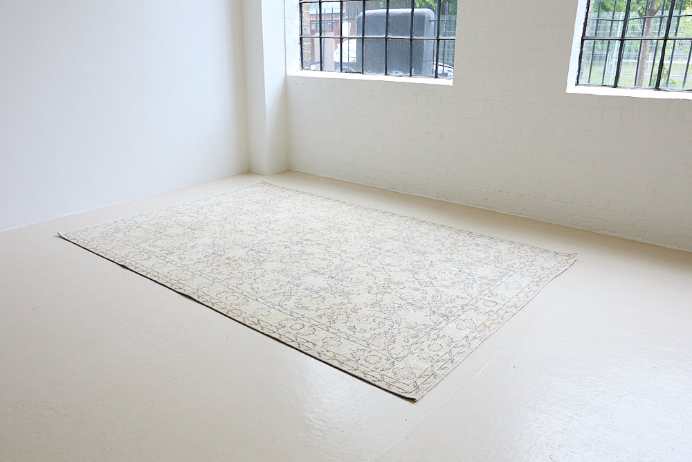 Lily is a vintage wool rug handwoven in Turkey approximately 80 years ago. The soft taupe field and is decorated with an all floral scrolls pattern framed by a subtle boarder.