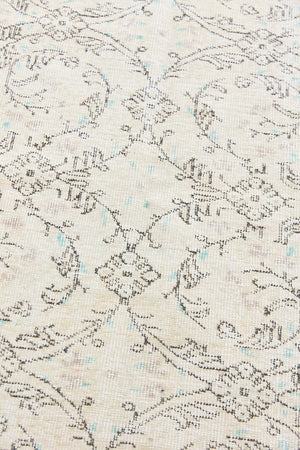 Lily is a vintage wool rug handwoven in Turkey approximately 80 years ago. The soft taupe field and is decorated with an all floral scrolls pattern framed by a subtle boarder.
