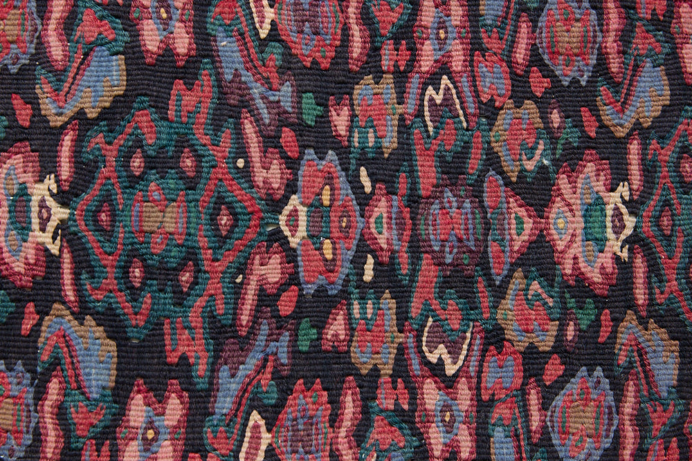 Woven in the Kurdish highlands of northwest Iran, Senneh kilims are distinguished by an exceptional fineness of weave with a tight slit-tapestry construction with a high level of intricacy. Celestine features a decorative all over pattern in pinks, blues and greens on a black field.