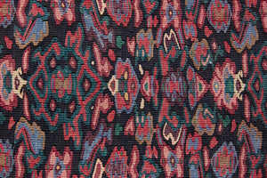 Woven in the Kurdish highlands of northwest Iran, Senneh kilims are distinguished by an exceptional fineness of weave with a tight slit-tapestry construction with a high level of intricacy. Celestine features a decorative all over pattern in pinks, blues and greens on a black field.